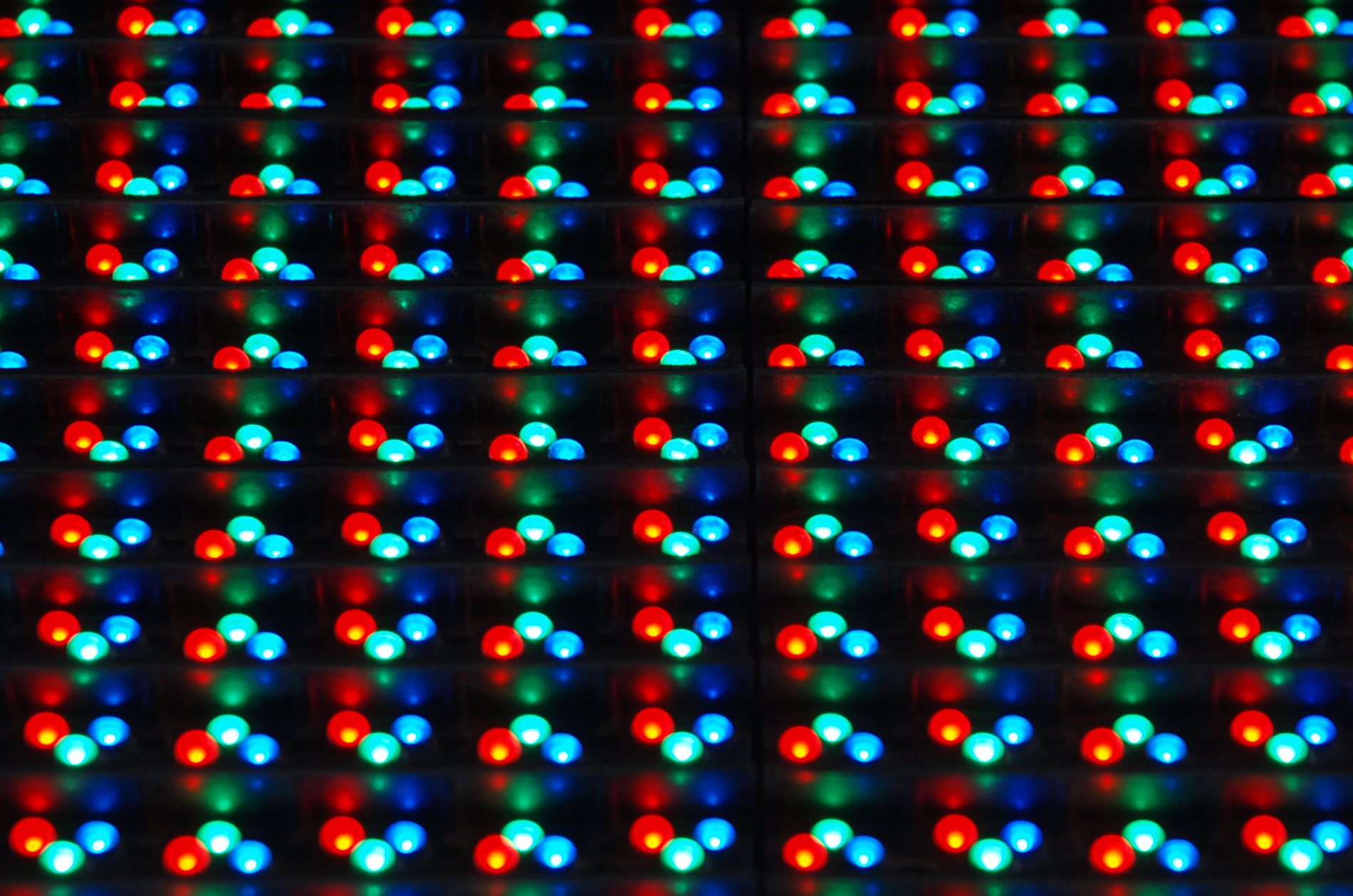 Closeup of tiny red, green and blue LEDs arranged in a matrix for a display.